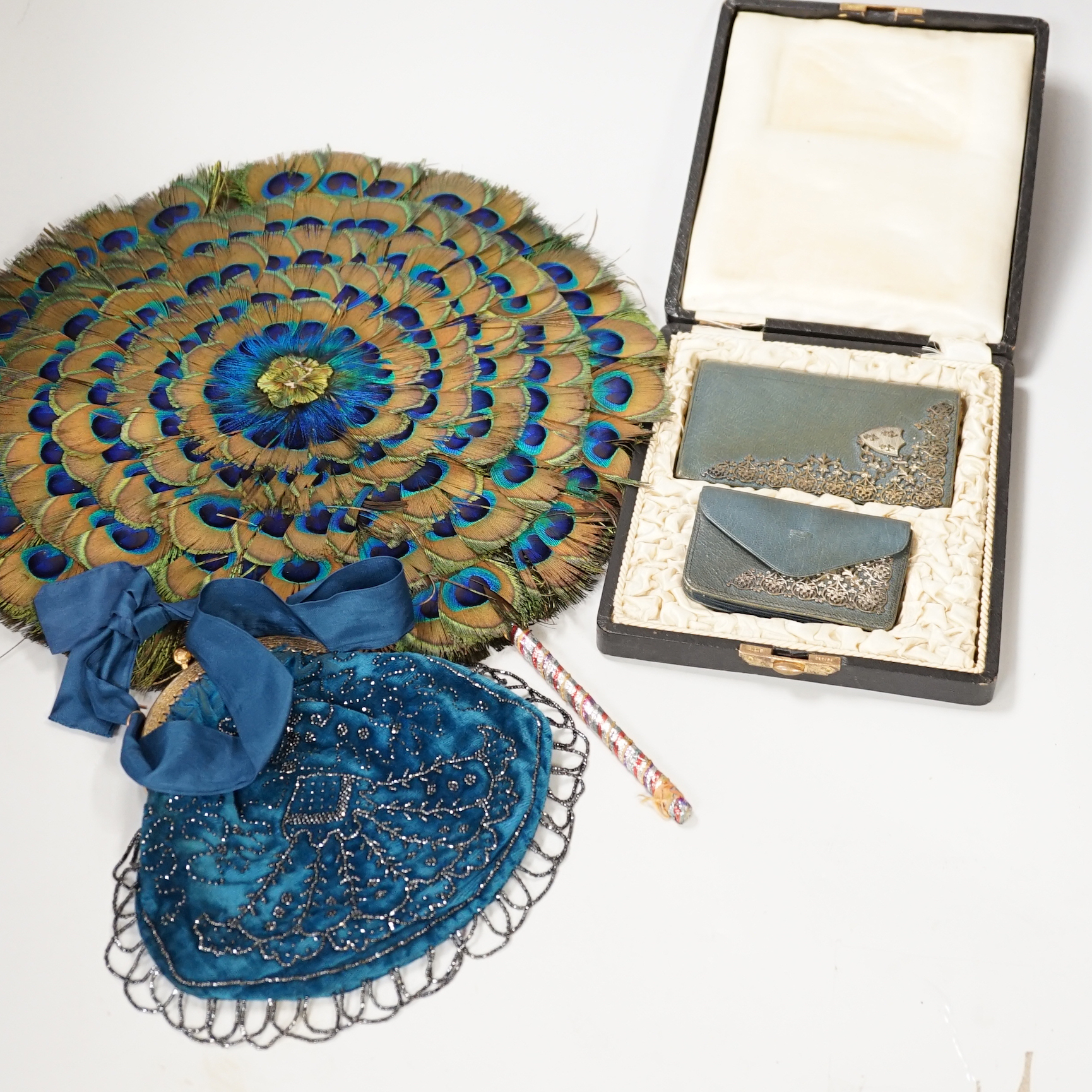 A 19th century peacock feather fan, a cut steel bag and a cased leather and silver mounted purse and card case, fan 41cm high